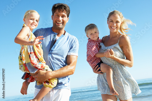 Photo: Family Having Fun On Beach Family Having Fun On Beach