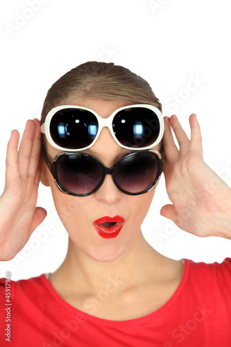 Photo: Woman wearing two pairs of sunglasses Woman wearing two pairs of sunglasses