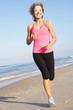 Senior Woman Exercising On Beach