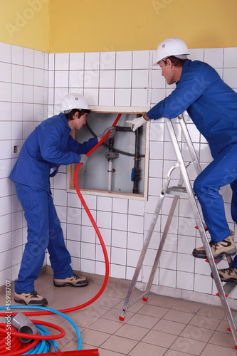 Photo: workers installing pipe workers installing pipe