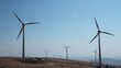 Field of wind turbines in function on a windy day