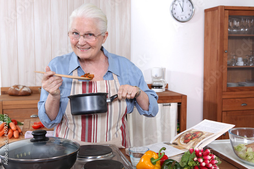 Photo: Older woman cooking a meal Older woman cooking a meal