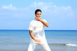 Photo: Handsome man on the beach meditating Handsome man on the beach meditating