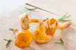 Chanterelles on wood with herbs