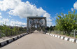 Old arched metal bridge in Novgorod region, Russia.