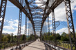 Old arched metal bridge in Novgorod region, Russia. View from in