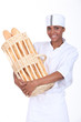 A baker holding a basket of bread
