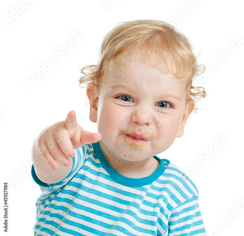 Photo: funny curly child with dirty lips pointing by finger directly to funny curly child with dirty lips pointing by finger directly to