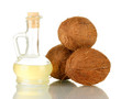 decanter with coconut oil and coconuts isolated on white