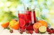 sangria in jar and glass with fruits,