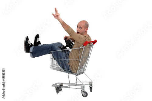 Photo: Man in a shopping trolley Man in a shopping trolley