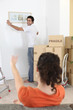 Man putting up a picture frame