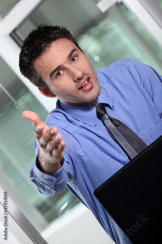 Photo: Businessman holding his hand out for a handshake Businessman holding his hand out for a handshake