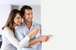 Cheerful couple looking at message on whiteboard