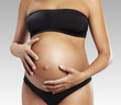 pregnant mother caressing her belly
