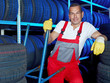 Car mechanic stores winter tires in a tire warehouse