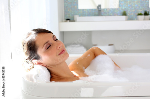 Photo: Beautiful woman relaxing in bathtub Beautiful woman relaxing in bathtub