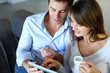 Mature couple at home using credit card to shop online