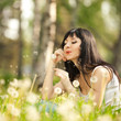 Cute woman in the park with dandelions