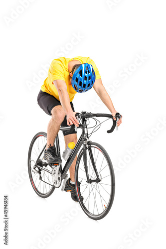 Photo: Full length portrait of a tired cyclist on a bicycle Full length portrait of a tired cyclist on a bicycle
