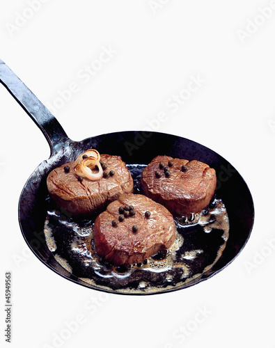Photo: Steaks in frying pan Steaks in frying pan