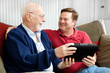 Photo: Father and Son Enjoying Tablet PC Father and Son Enjoying Tablet PC