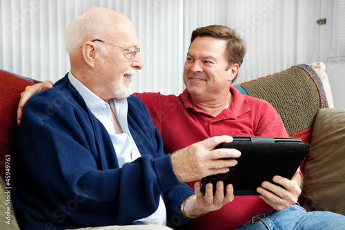 Photo: Father and Son Enjoying Tablet PC Father and Son Enjoying Tablet PC