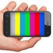 Hand holding mobile smart phone with tv test pattern screen.