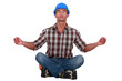 Laborer sitting in a yoga posture