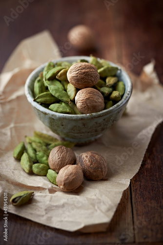 Photo: Dried cardamon pods and nutmeg in a dish Dried cardamon pods and nutmeg in a dish