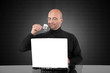 Man drinking espresso and looking happy to his laptop