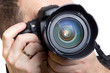 Photographer taking pictures with digital camera over white