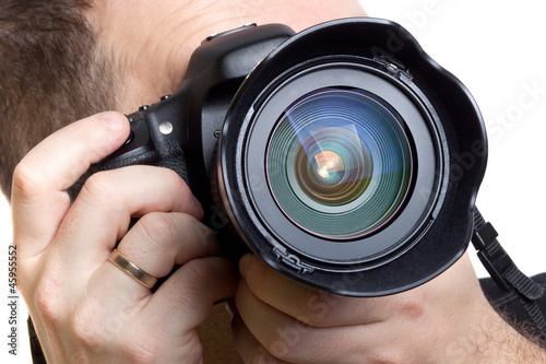 Photo: Photographer taking pictures with digital camera over white Photographer taking pictures with digital camera over white