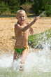 Photo: Little girl running through the water Little girl running through the water