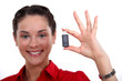 Brunette holding USB stick