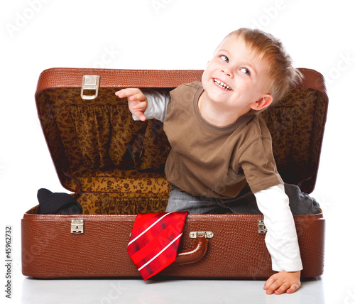 Photo: A funny boy with sombrero is in the suitcase A funny boy with sombrero is in the suitcase