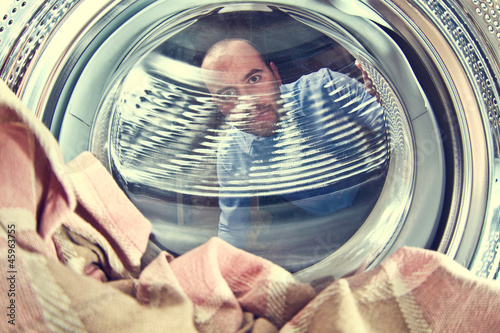Photo: man and washing machine man and washing machine