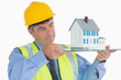 Architect holding a glass slide with miniature house