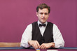 Dealer sitting in a casino distributing chips