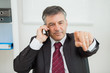 Foto: Businessman phoning and pointing Businessman phoning and pointing