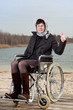 Woman with suitcase wheelchair and walk on the road