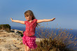 blue day with kid girl open hands to the wind