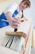 Woman pasting wallpaper