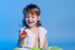 Little girl looking at strawberry