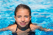 blue eyes kid girl at the pool face in water surface