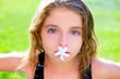 blue eyes kid girl with jasmine flower in mouth