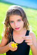 children girl testing love with yellow daisy flower petals