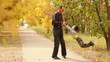 father turns his son on a background of autumn alley