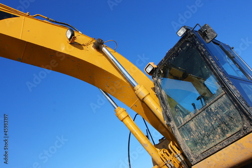 Photo: Hydraulic excavator against a blue sky Hydraulic excavator against a blue sky