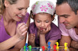 Young family playing a board game